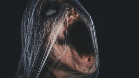 Screaming creepy character covered with spiderweb Stock Footage 129696045