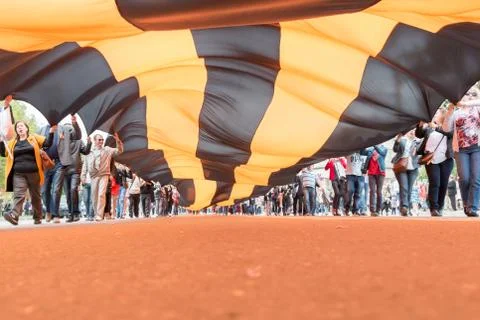 The screaming crowd go to the camera and carries a huge St. George's ribbon Stock Photos