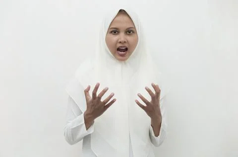 Screaming, hate and rage concept. Angry emotional muslim woman in hijab shouting Stock Photos