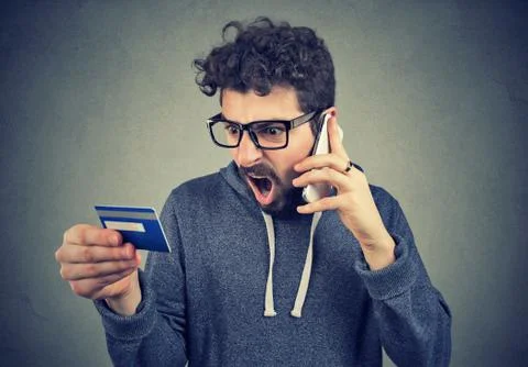 Screaming man solving problems with credit card Foto stock