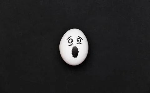 Screaming scared hand-drawn egg face on black background Stock Photos
