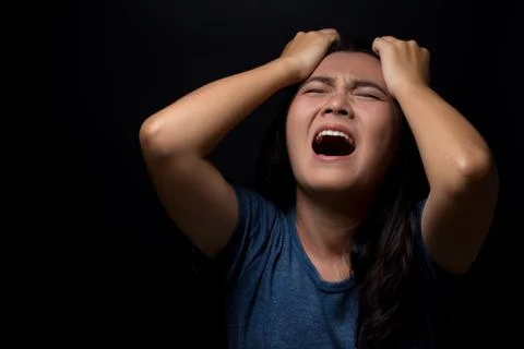 Screaming woman on black background Stock Photos