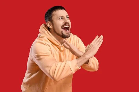 Screaming young man rejecting something on red background Stock Photos