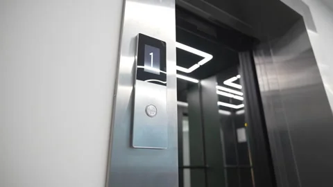 Screen above elevator call button shows floor position Video stock 324908577