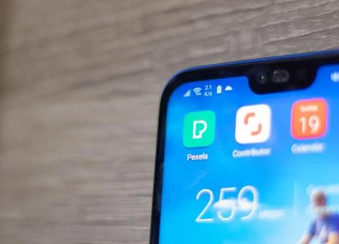 Screen of an android device with Pexels and Shutterstock contributor app icon Stock Photos