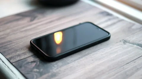 Screen of black iPhone 11 showing on wooden table Stock Footage 144337988