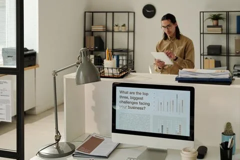 Screen of computer with various types of data on workplace of manager 스톡 사진