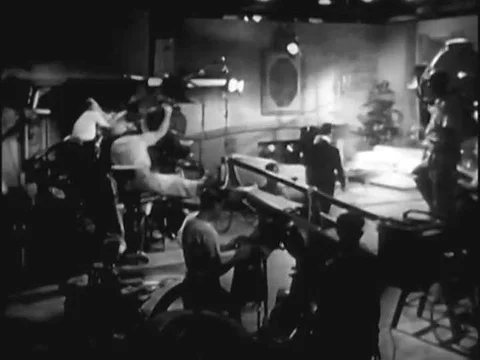 A screen director works with an editor and a composer at Warner Bros. studios Stock Footage 74936734