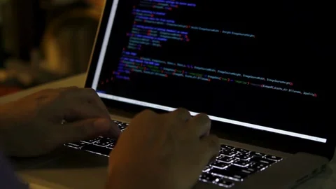 Screen full of code in real time Extreme close-up human hands. Closeup coding on Vídeos de archivo 334586104