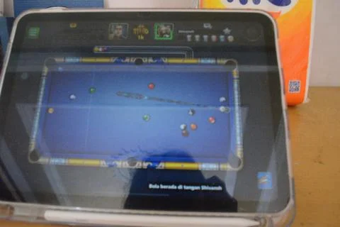 Screen of an iPad displaying 8 ball pool game application during the game Stock Photos