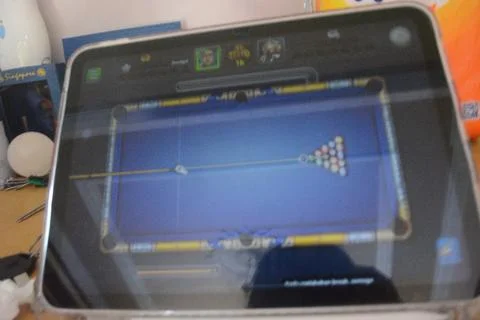 Screen of an iPad displaying 8 ball pool game application during the game Stock Photos
