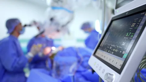 Screen of lung ventilating machine with life parameters. Group of doctors in Stock Footage 333337065