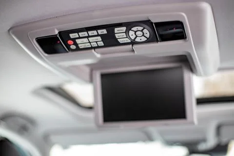 Screen m multimedia system control panel on the ceiling of a modern car. close Foto stock