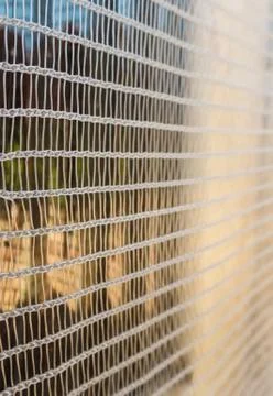 Screen, net or white mesh in the window of a house Stock Photos