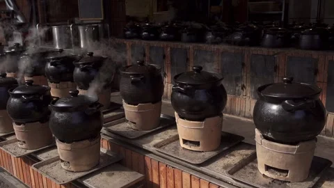 Screen panning to the left of dozens of clay pots steaming,4K Video stock 296594017