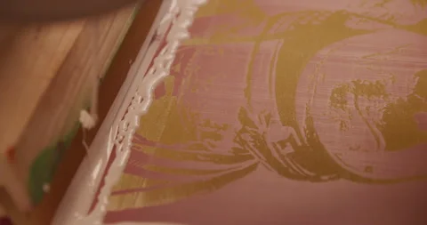 Screen printer pors and spreads ink for tee shirt printing Stock Footage 248324441