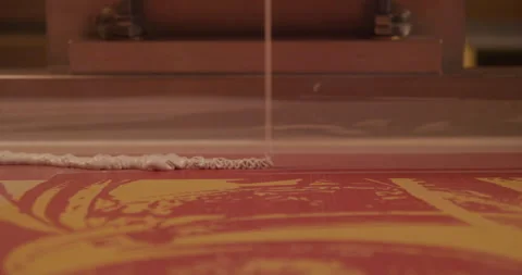 Screen printer pours ink for tee shirt printing Stock Footage 248324354