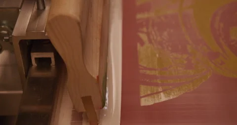 Screen printer screen prints a tee shirt 1 Stock Footage 248324328