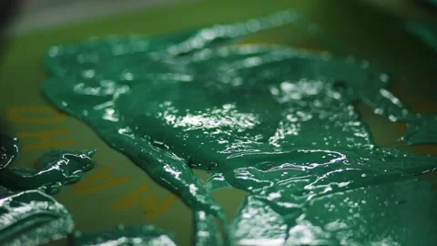 Screen printing ink with squeegee. Green and yellow paint on press Stock Footage 139387403