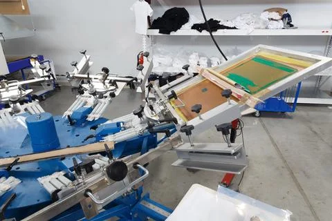 Screen printing machine for applying images by silkscreen printing. Stock Photos