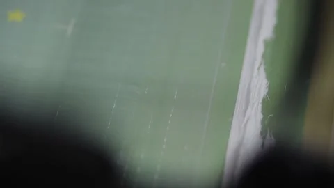 Screen printing silk screen with squeegee applying white paint on Stock Footage 139387380