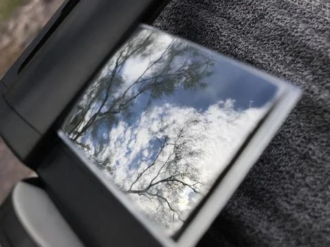 Screen Reflection of Tree Branches Against Cloudy Sky Stock Photos