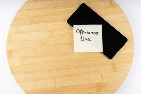 Off-screen Time" Reminder Note on a Smartphone Lying on a Wooden Surface, S.. Stock Photos