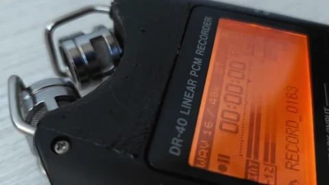 Screen with wave form of speech recording on digital voice audio dictophone Stock Footage 219939216