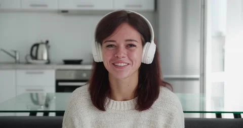 Screen webcam view of joyful young woman in earphones talk before camera with Stock Footage 166689529
