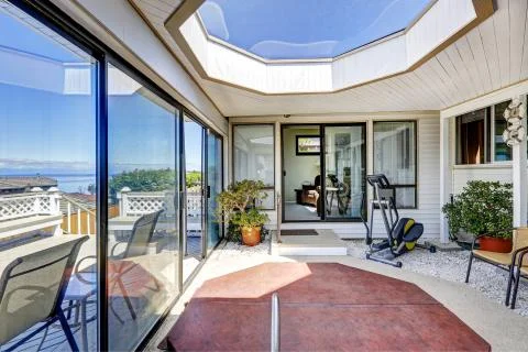 Screened deck with jacuzzi, exercise equipment and skylihgt Stock Photos