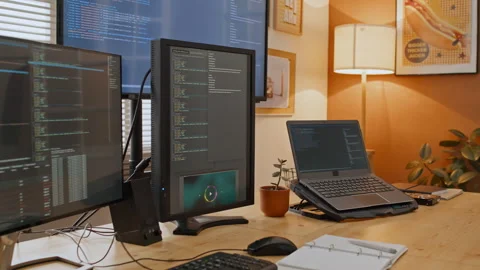 Screens with Computer Code on Desk of Developer Working from Home Stock Footage 255930909