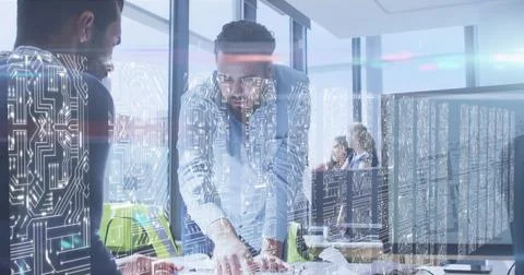 Screens with microprocessor connections against diverse two male colleagues 写真素材