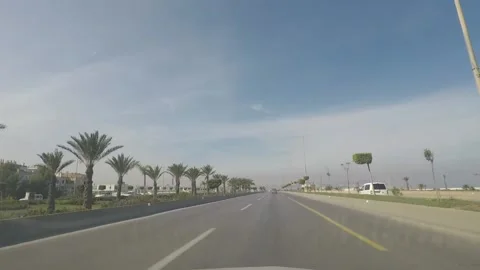Screenshot from inside a car of a highway in Algiers with some palms on its side Video stock 149000742