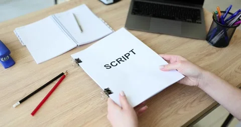 Screenwriter holds folder of documents labeled script Stock Footage 241680105