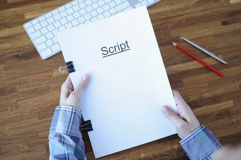 Screenwriter holds folder of documents labeled script Stock Photos