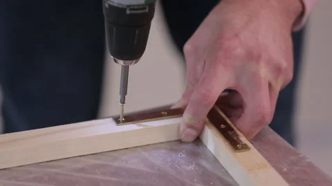 Screw is being driven into a board with a screwdriver Stock Footage 95528063