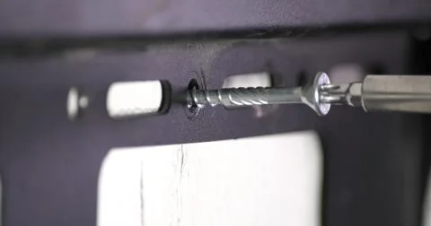 Screw being fastened into a wall using a drill bit during home improvement proje Foto stock