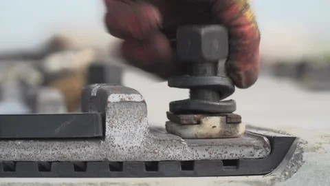 Screw the bolt into the threaded hole. Stock Footage 316144211