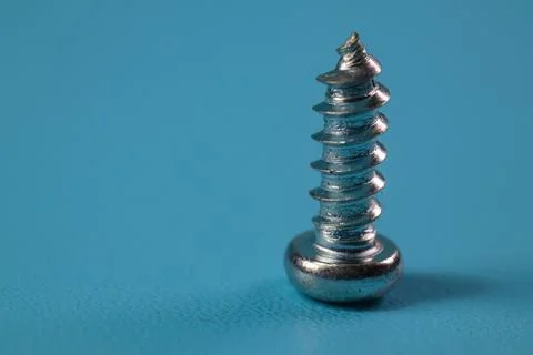 Screw in closeup on blue background Stock Photos