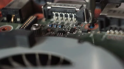 The screw of the coptuter is inserted and twisted into the groove Stock Footage 166043369