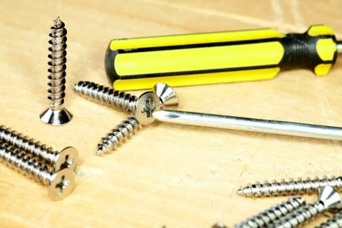 Screw-driver screws on a  board Stock Photos