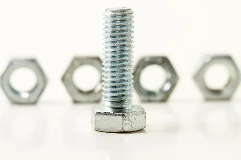 Screw in front of four Stock Photos