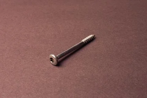 Screw with an internal hexagon on a brown background. Creative vintage backgr Foto stock