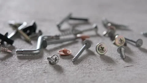 Screw, nail on concrete texture background. Closeup of screws and nails on .. Stock Footage 274469171