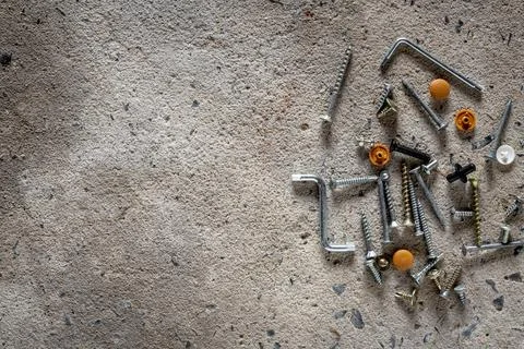 Screw, nail on concrete texture background. Closeup of screws and nails on .. Stock Photos