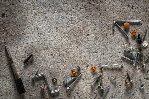 Screw, nail on concrete texture background. Closeup of screws and nails on .. Stock Photos