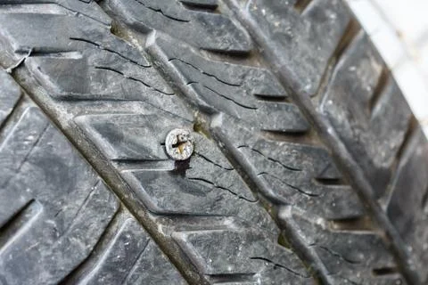 Screw puncturing tire Foto stock