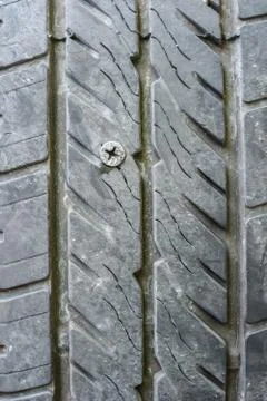 Screw puncturing tire Stock Photos
