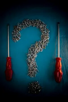 Screw Question Mark and Screwdrivers Stock Photos