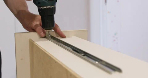 Screw removing from metal rail with powered screwdriver Stock Footage 323967423